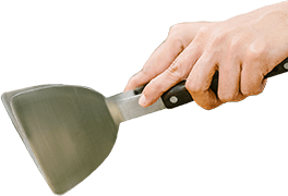 Hand with grill scraper